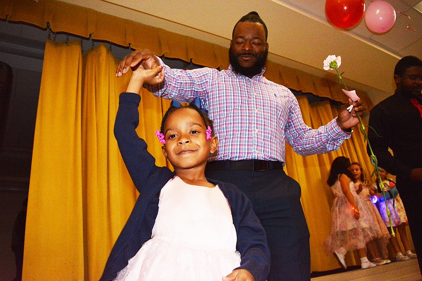 Kindergartner Sariyah Walker practices twirling with her dad, Devante Walker. Sariyah Walker takes ballet.