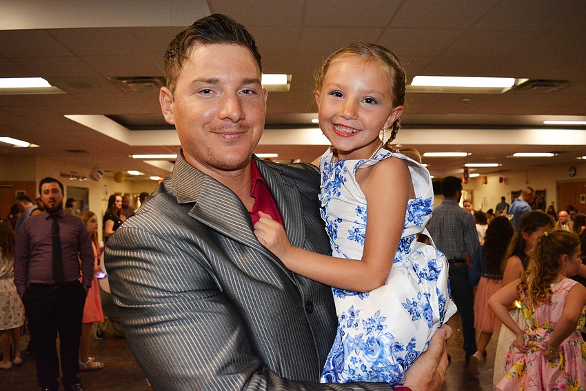 Josh Yoder gave his 5-year-old daughter, Angelina, a prime spot for watching others on the dance floor. 
