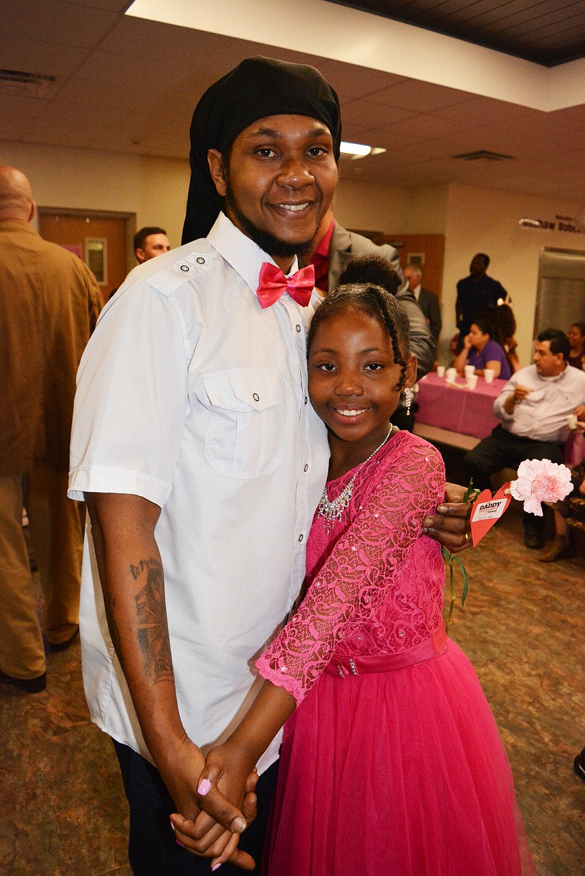 Second grader Cayden Hunter, pictured with her father Bradine Davis, wore a new dress just for the dance. Her mother, Tara Davis, added sparkles to it.