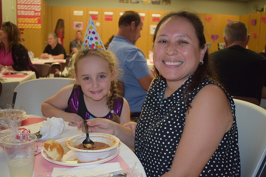 Abrianna Williams, who is 5 years old, supports students at Braden River Middle School with her mother, Abigail Williams, who is a Spanish teacher at the school.