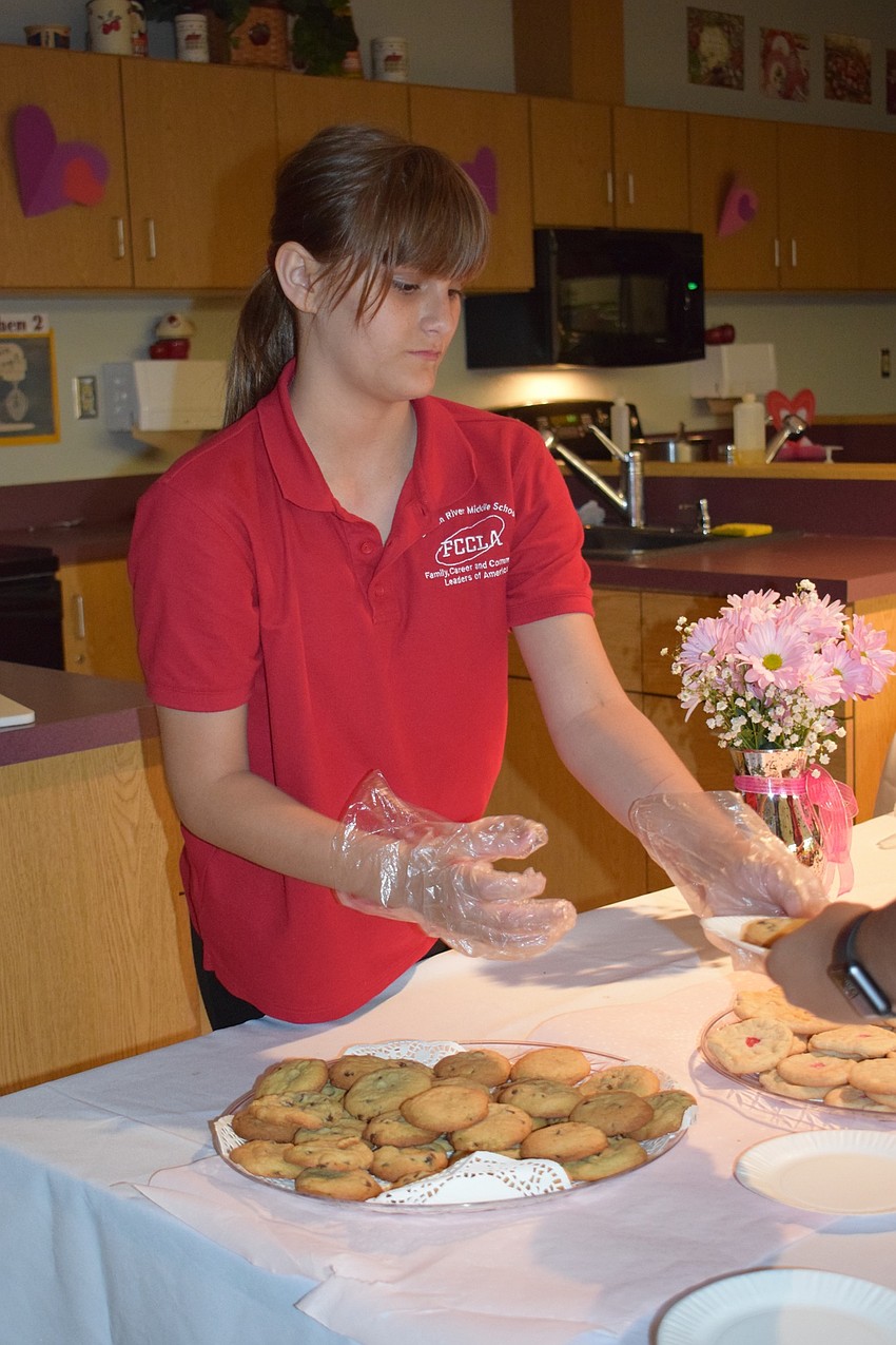 Layna Fennell, a sixth grader, serves desserts. Fennell joined Family Career and Community Leaders of America because she thought 