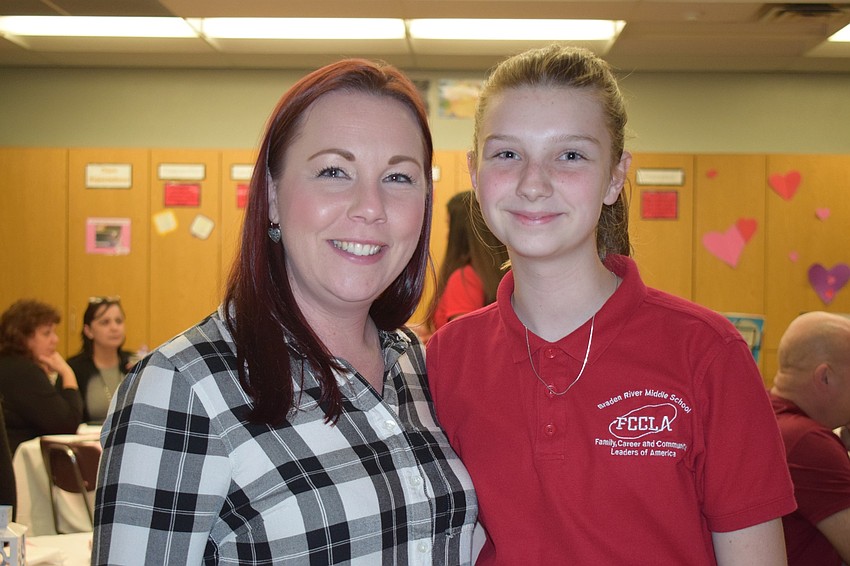 Michelle Lippincott supports her daughter, Jade, who is a seventh grader, during Empty Bowls. 