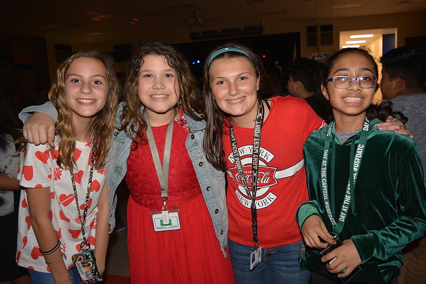Sixth graders Madelyn Boyd, Ireland Coleman, Alexis McInerney and Namita Kondabala love being with friends at the dance.
