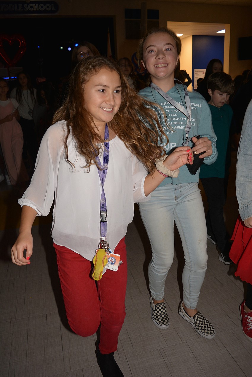 Sixth grader Olivia Autrey and friend Hana Pierce dance to the 