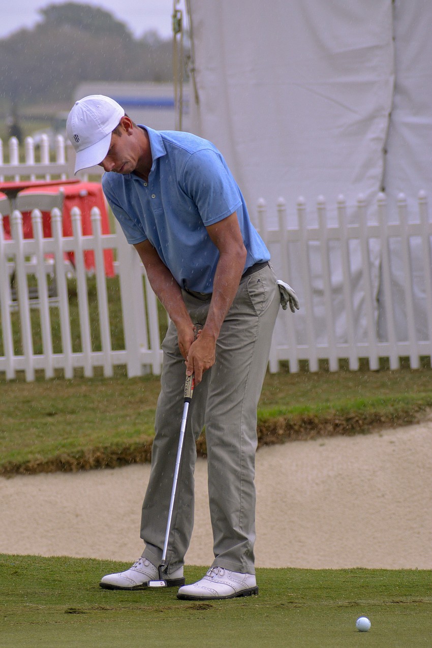 Vince India putts for par on the No. 18 hole at Lakewood National.