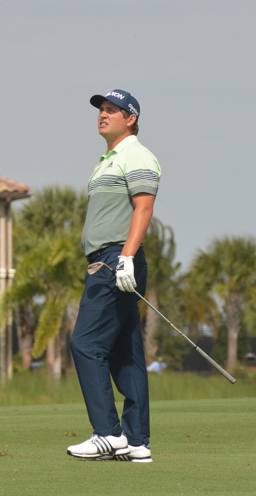 Greyson Sigg watches his second shot on the No. 1 hole at Lakewood National hit the green.  Sigg is 15 under par and tied for fourth after round three.