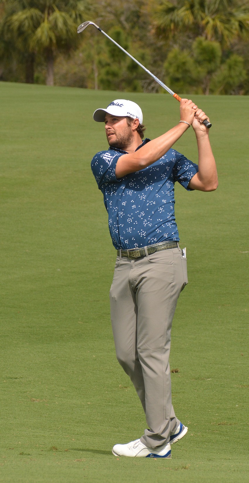 Peter Uihlein hits his second shot on the No. 1 hole at Lakewood National. Uihlein finished day three in the lead at 18 under par.