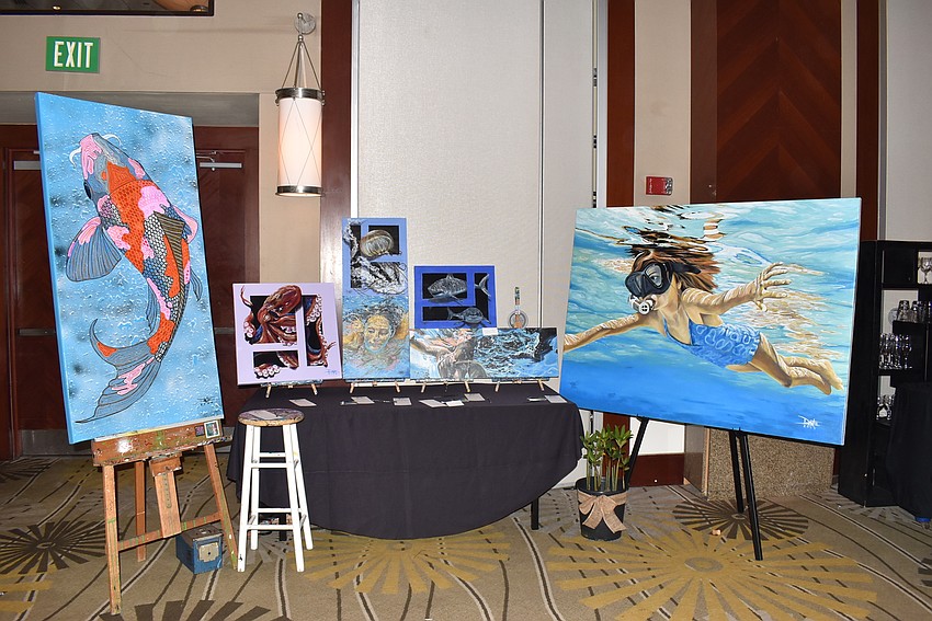 Paintings by Dante Ferraro were available as auction items.