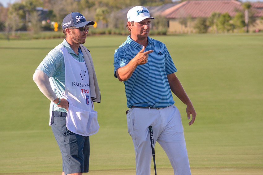 Andrew Novak chats with his caddie.