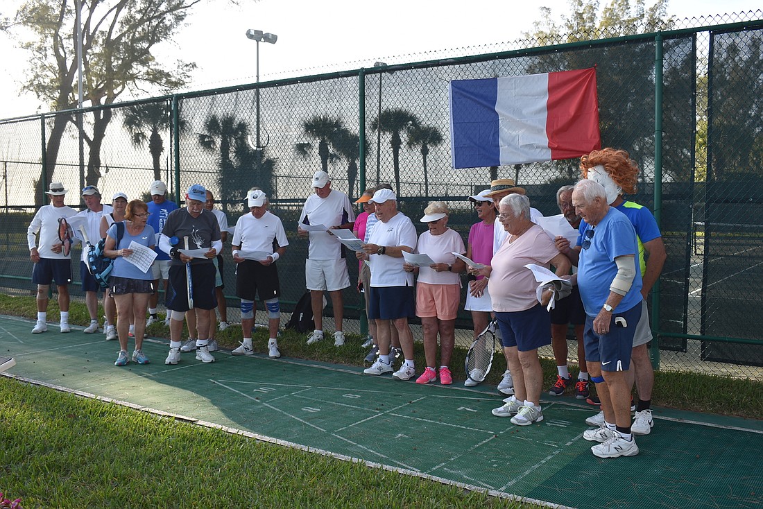 Players sing in French before the tournament begins.
