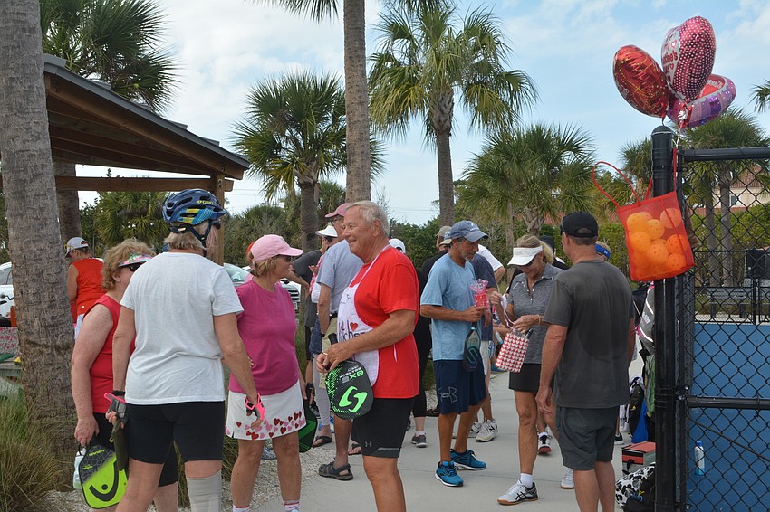 Pickleballers socialize during the Beauty and the Beast tournament Friday.