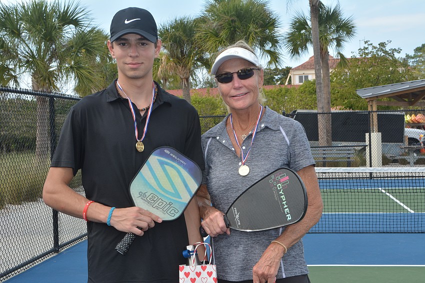 Mother-son team Zac (left) and Helen Smith pose after winning the challenge bracket of the Beauty and the Beast tournament Friday.