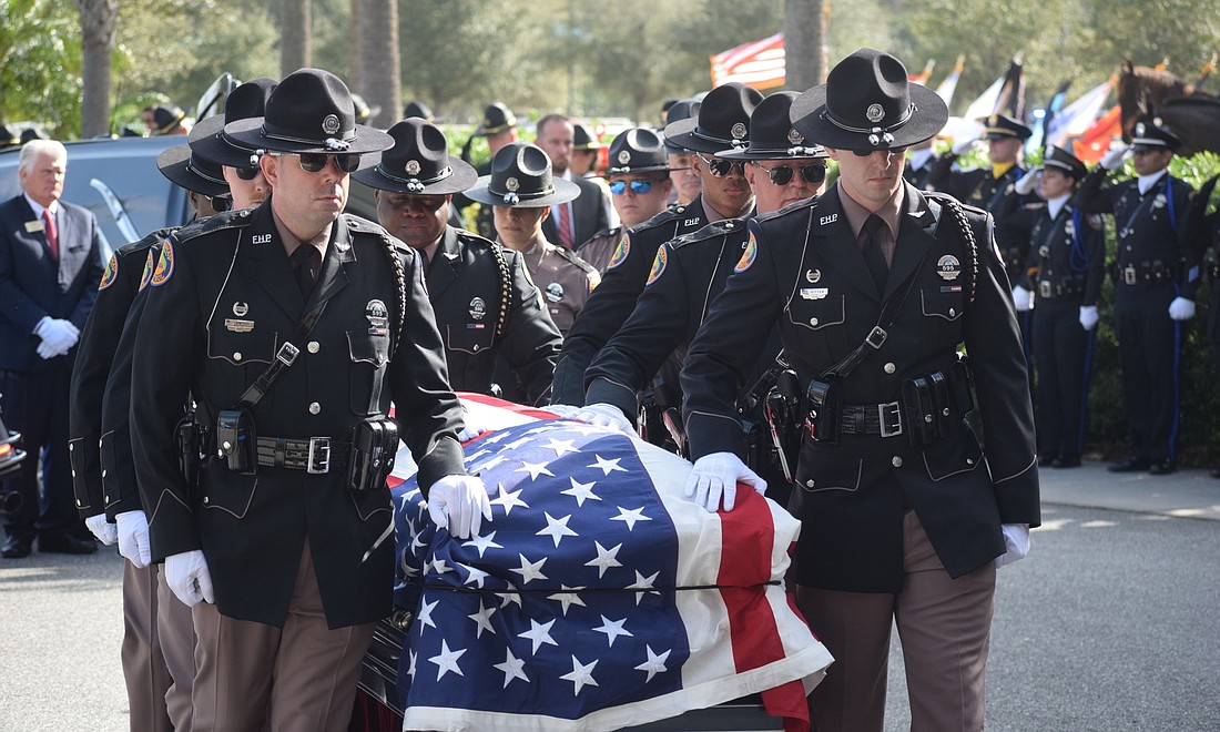 Troopers Ryan Dwyer and Alec Ritter of the Florida Highway Patrol&#39;s Central Region Honor Guard lead the casket of Trooper Joseph Bullock into Bayside Community Church Feb. 13.