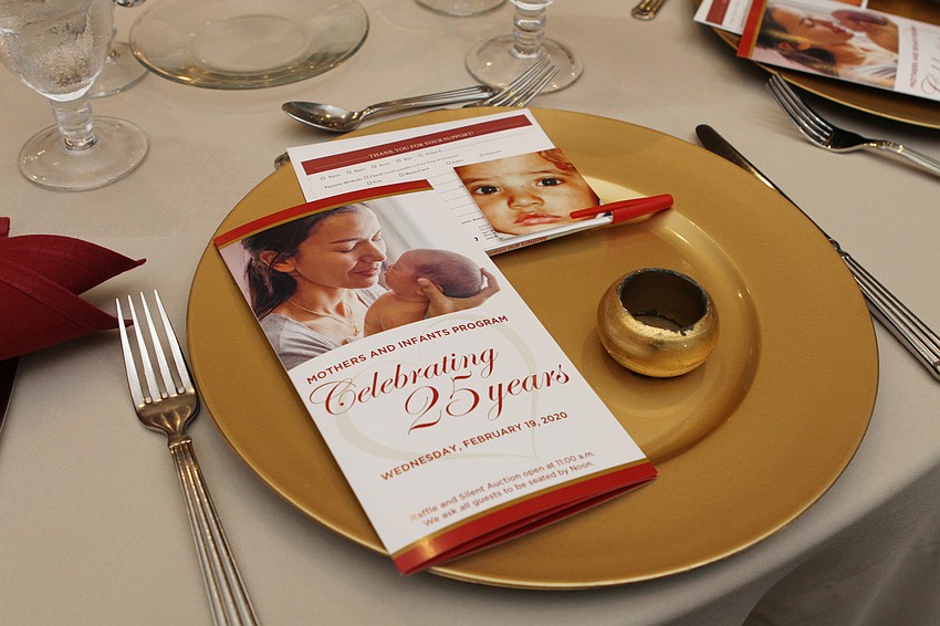 Each seat had photos of children helped by the Mother and Infants program.