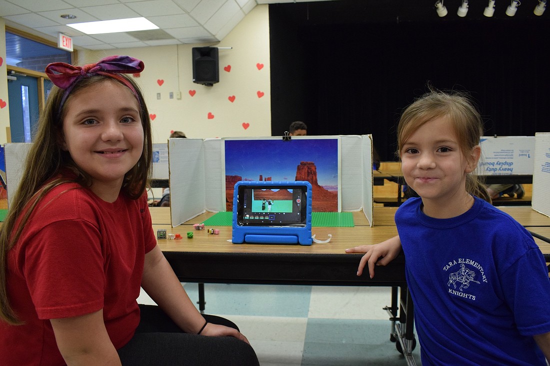 Lynita Chupps, a fourth grader, works with her sister, Lisa Chupp, a second grader, on their stop-motion movie. The pair are working on the storyline as they go.
