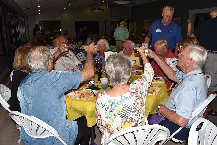 Residents toast to the evening.
