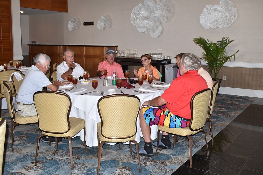 Attendees grouped together to chat after the round.