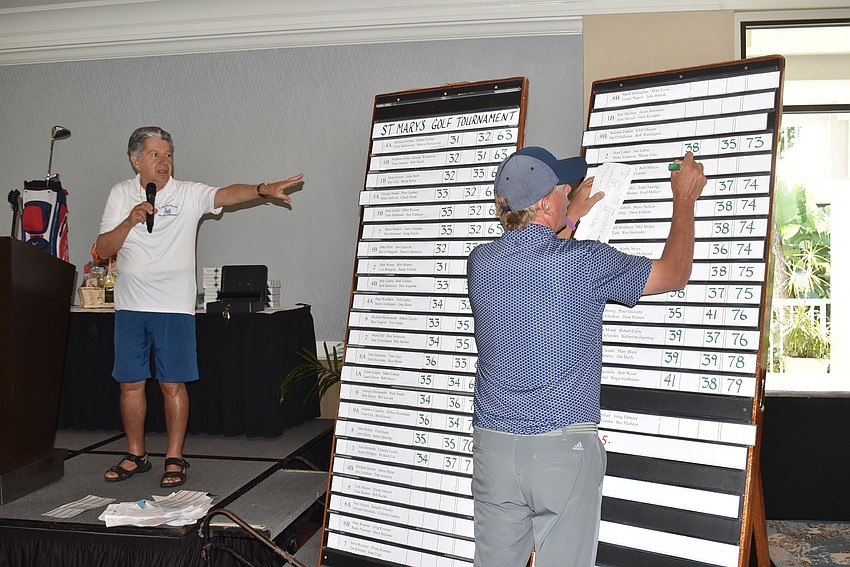 Lenny DiStefano instructs attendees to give their score cards to Terry O'Hara, so the winners could be recognized.