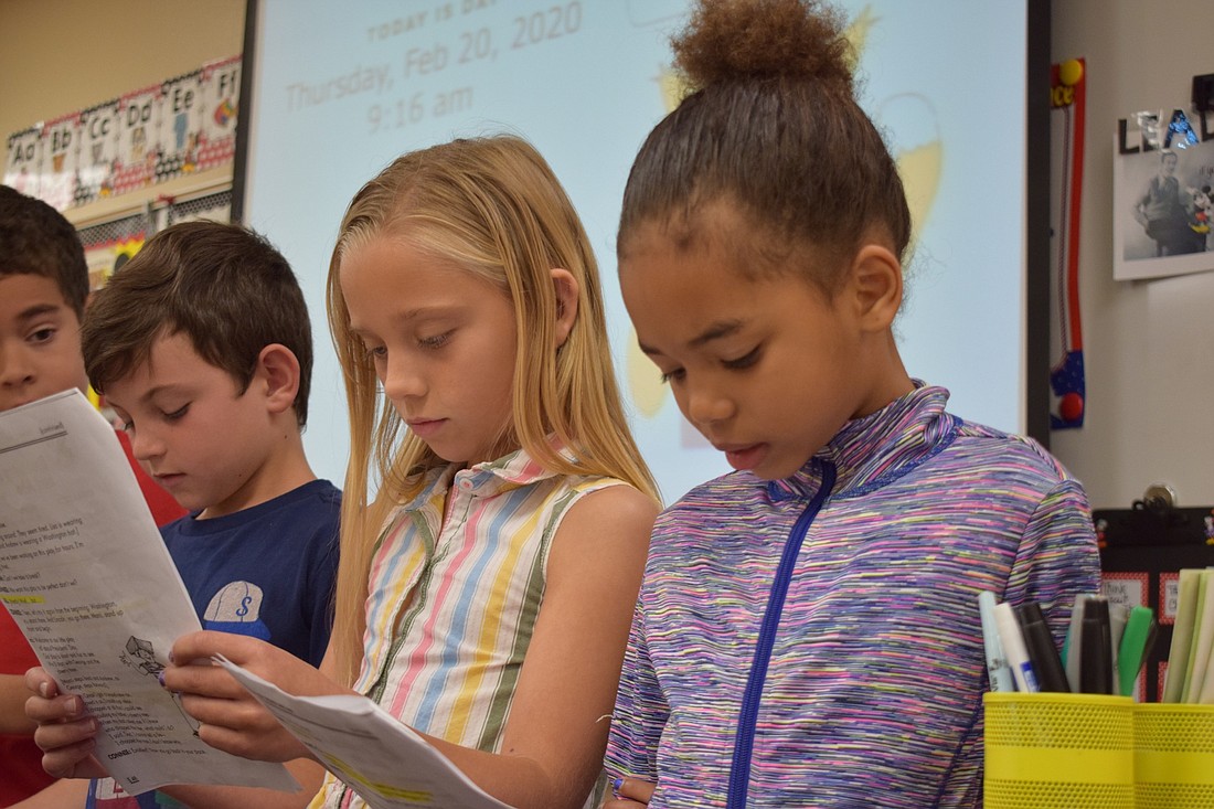 Second graders Hayden Laning, Charlotte Eldridge and Jullian Riley play different characters in their group&#39;s readers&#39; theater about presidents.