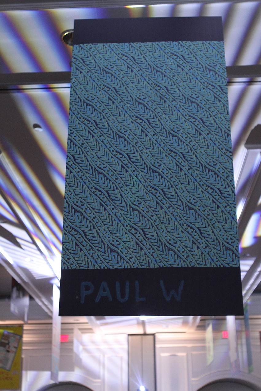 Quilts honoring CAN Community Health patients who died from AIDS hung from the ceiling.