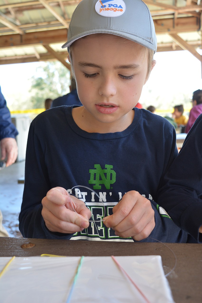 Nine-year-old Lakewood Ranch resident Ryan Lahey learns to tie various knots used for fishing.