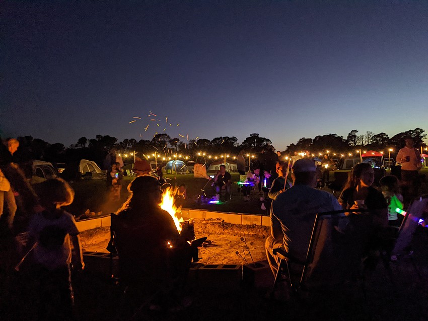 Lakewood Ranch residents gather around a campfire  to roast marshmallows and make s'mores.