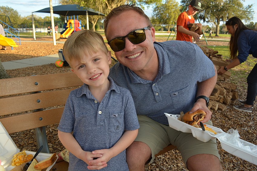 Four-year-old Zeke Wiget and his dad, Levi Wiget, walked over from their home in Greenbrook and grabbed barbecue from Nancy's Bar-B-Q, which had a food truck on site.