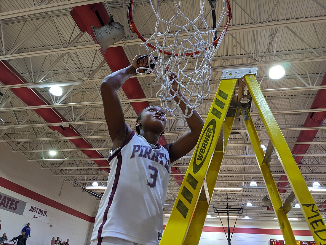 Braden River junior O&#39;Mariah Gordon cuts down the nets after defeating Fort Myers High in the regional finals Feb. 21.