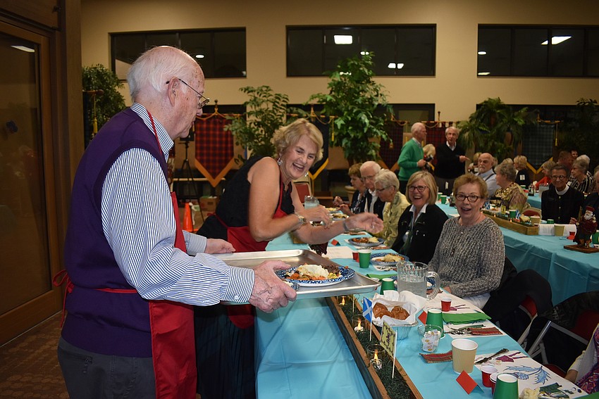 Whit and Cathy Daily serve dinner.