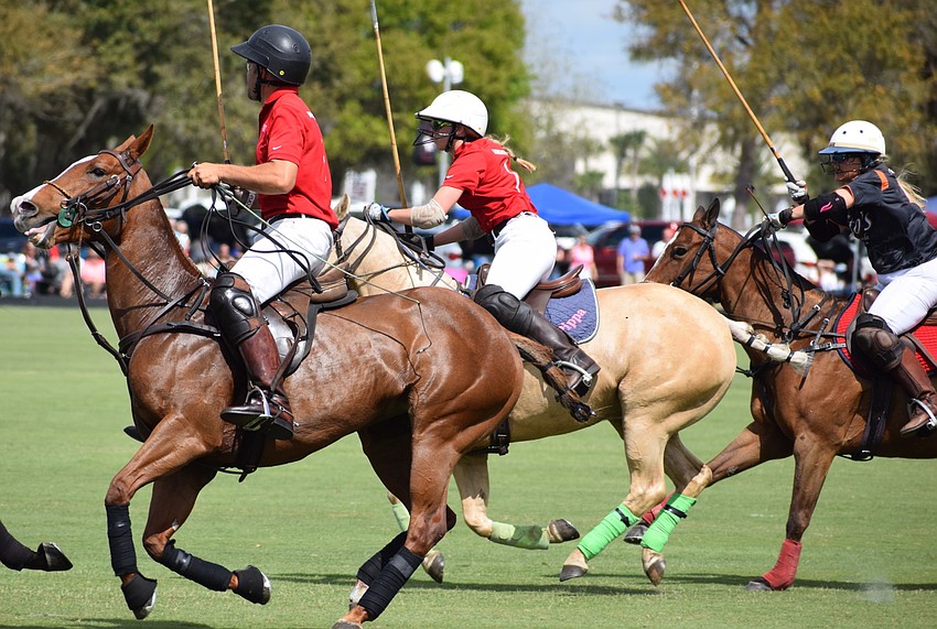 Hillcroft's Neil Osburg and Pippa Campbell and Tito's Kelly Beck race after the ball