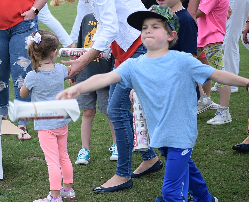 Sarasota 6-year-old Jeff Segal won a prize for his heave in the Observer Toss contest. He landed the paper right near the door mat at halftime of the polo match.