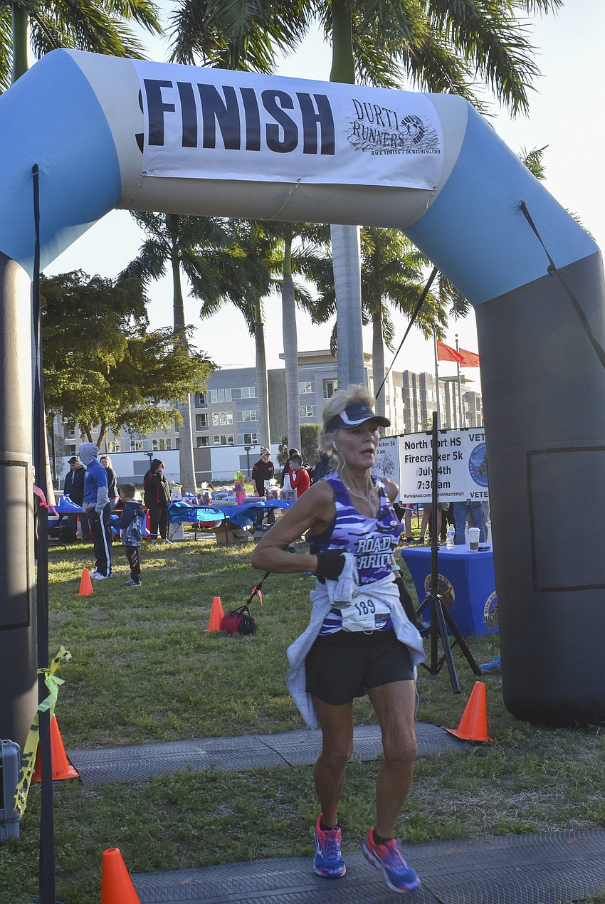 Barbie Ambuehl crosses the finish line.