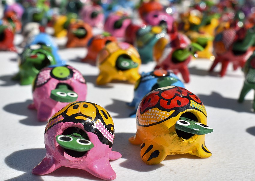 Brightly colored turtles were created from walnut shells.