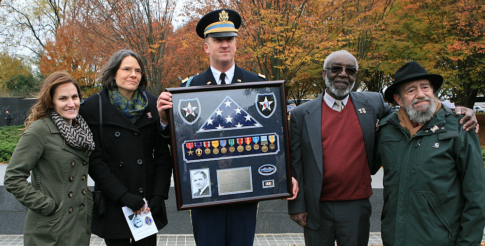 Zachariah Fike (center), a major in the Vermont National Guard, has returned more than 800 medals of valor to families of the soldiers.
