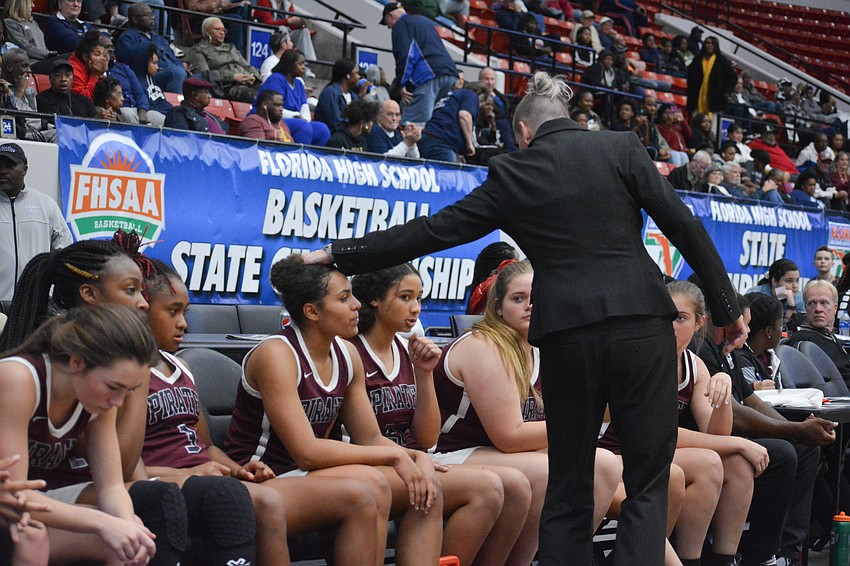 Stephanie Smith comforts senior Julia Rodriguez on the bench.