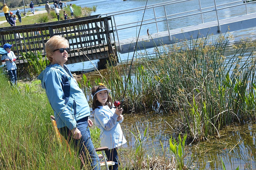 Lakewood Ranch's Kathy Staddler helps her daughter, 8-year-old Laura Staddler, perfect her cast.