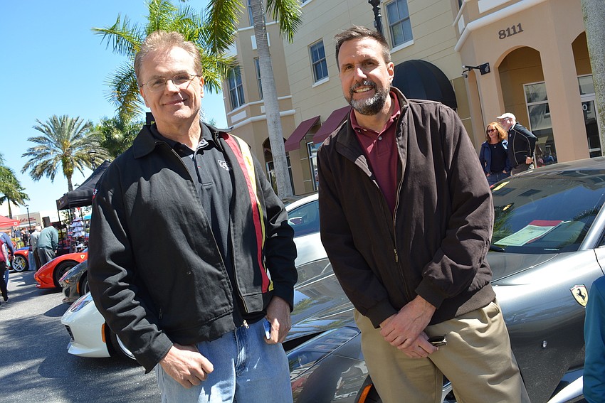 Sarasota's Zig Paul and friend Mark Roback check out some of the other vehicles. Paul showed his 1974 MGB.