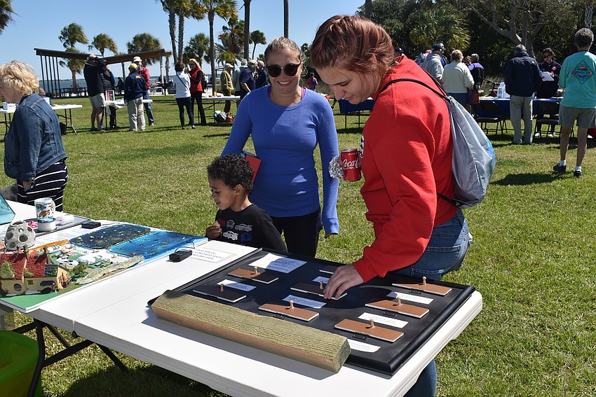 Renee, Jaxon and Rachel DeBickero check out the Turtle Watch exhibits.