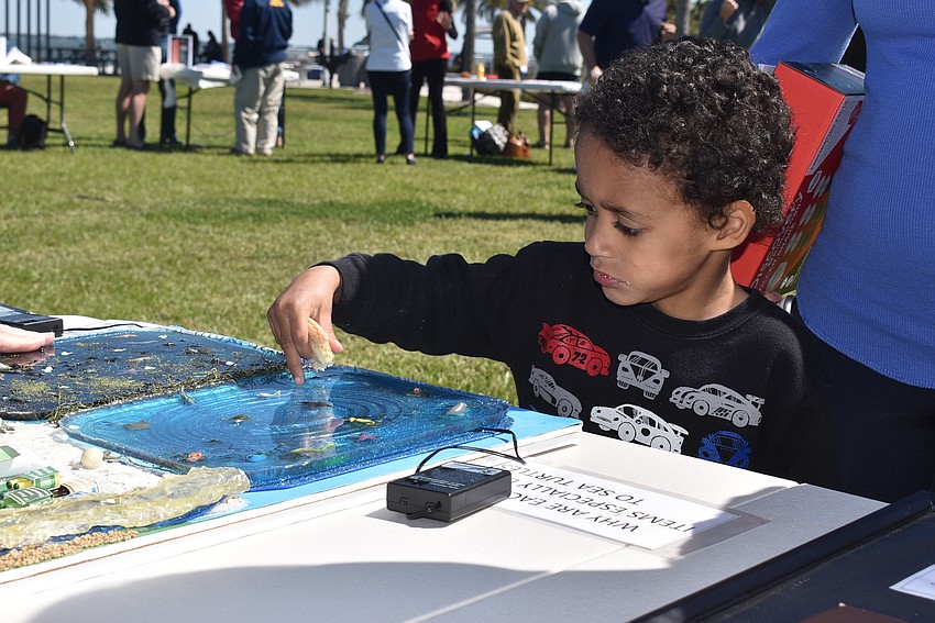 Jaxon DeBickero looks at a Turtle Watch diorama.
