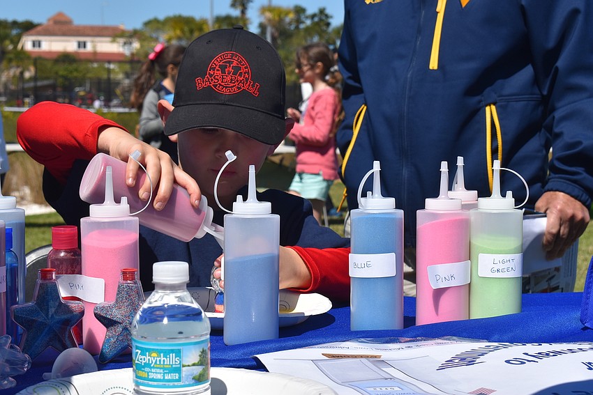 Kolton Adams makes sand art.