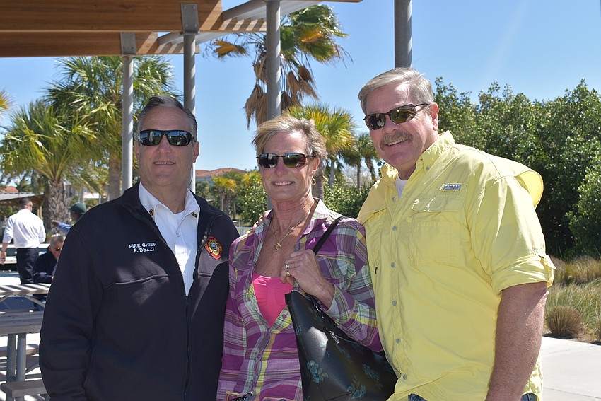 Fire chief Paul Dezzi with Diane and Pete Cumming.