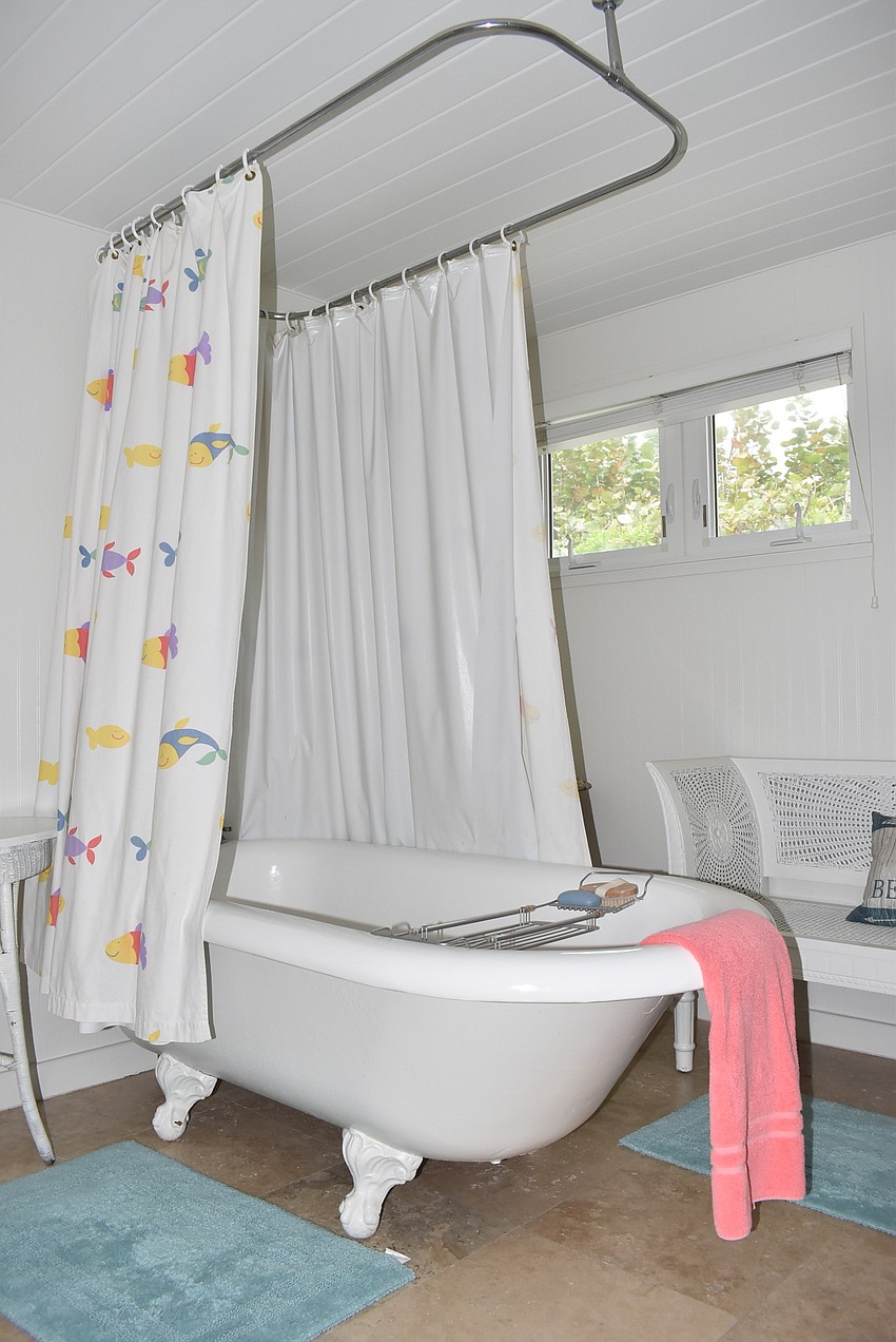 A clawfoot tub is the centerpiece of the main bathroom.