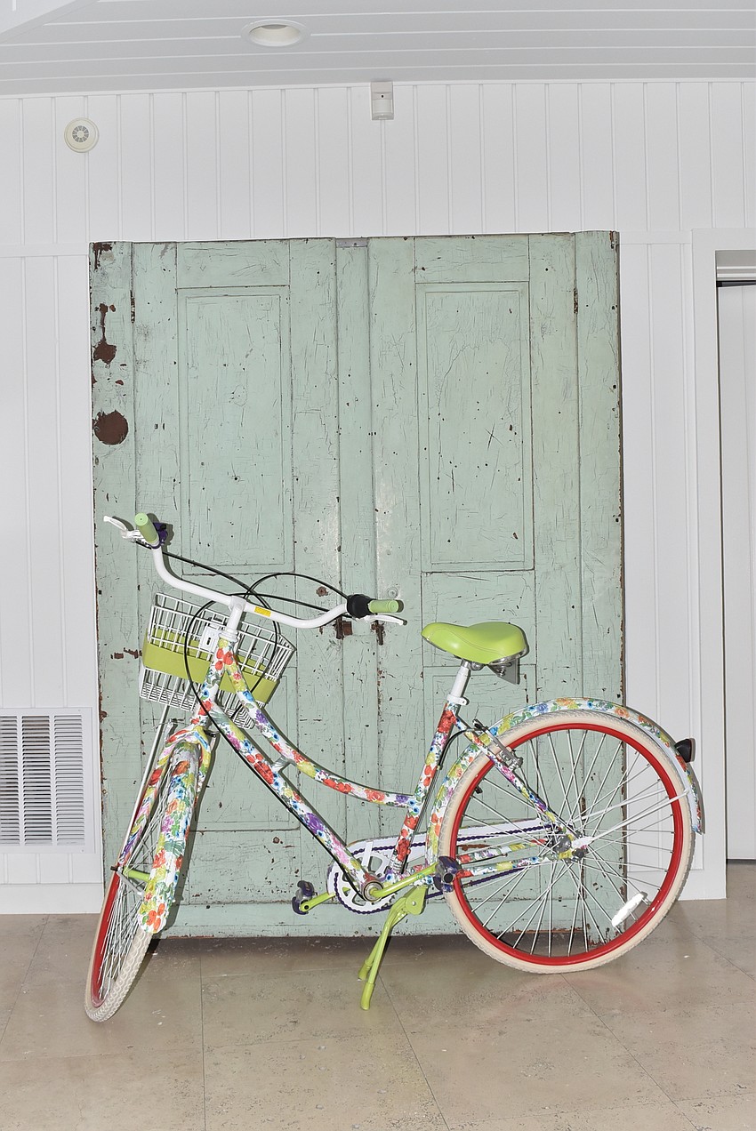 A colorful bike fronts a salvaged chest.