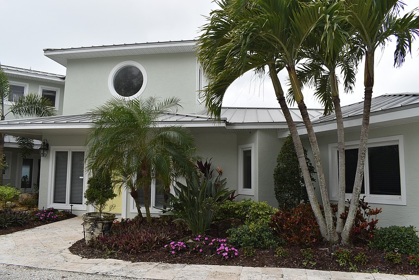 The former bungalow boasts a Floridian landscape.