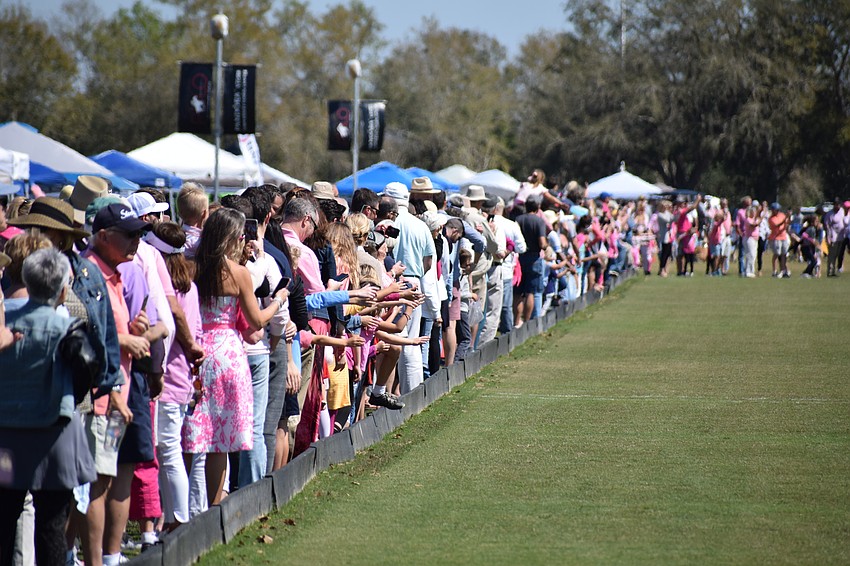 Fans lined to the field hoping to get a high-five from a player before the start of the Sarasota Women's Challenge.
