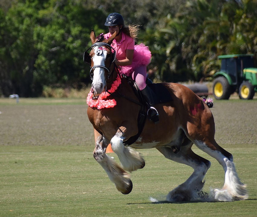 Jacintha Spruyt, who was presenting the American flag during opening ceremonies aboard a Clydesdale, had to hang on tight as her mount got a little frisky during warm-ups.