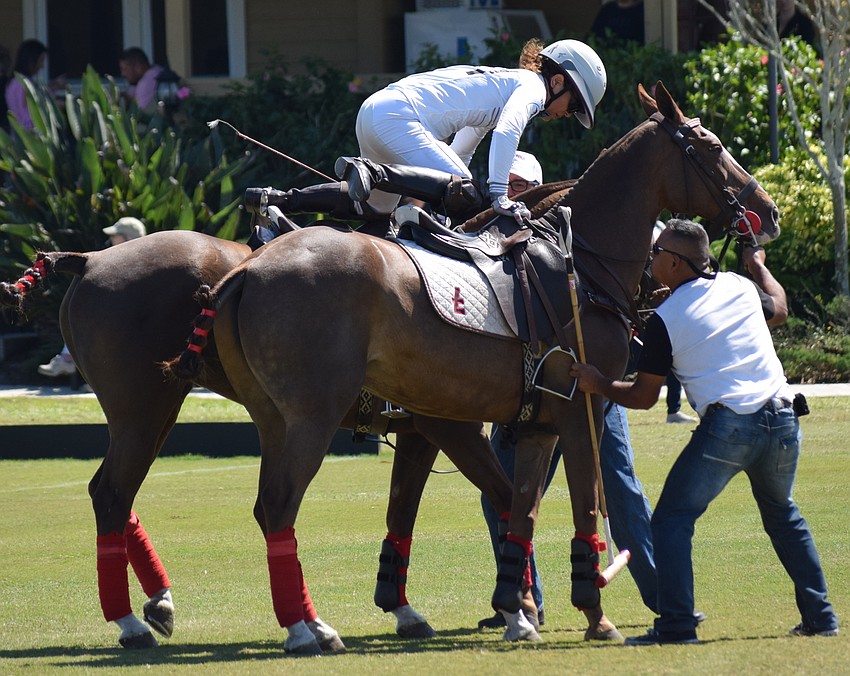 Dawn Jones of San Saba jumps from one horse to another to get a fresh mount during the Sarasota Women's Challenge.