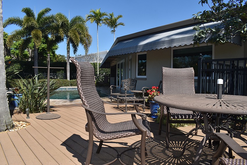 The sunny backyard also boasts a pool.