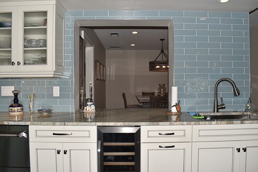 A cutout in the kitchen peeks into the dining area.