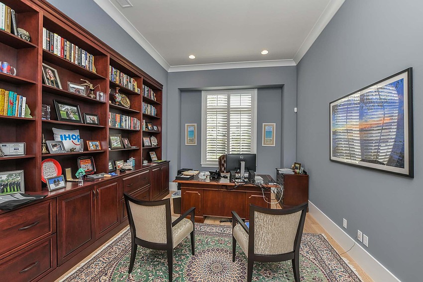 The den balances dark wood with light paint. Photo courtesy of Angela Nutter.